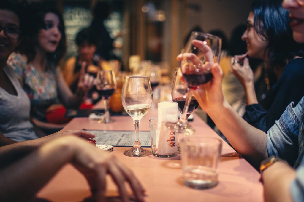 pexels photo 696218 people drinking liquor and talking on dining table close up photo